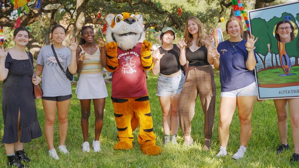 A group of 7 women students pose with the LeeRoy Tiger mascot