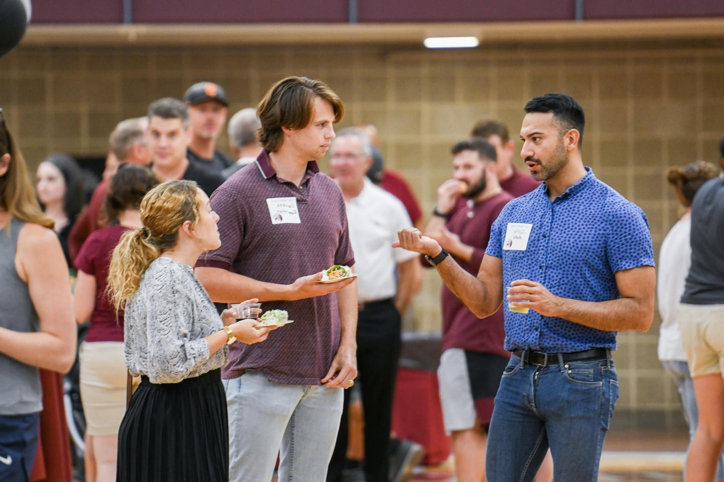 Staff from the Strategic Communications and Marketing office mingling at the faculty and staff welcome back party