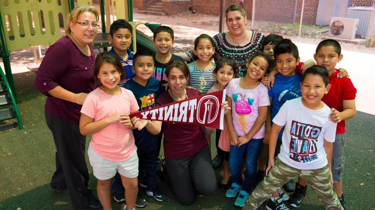 Group photo of an elementary class holding a Trinity pendent