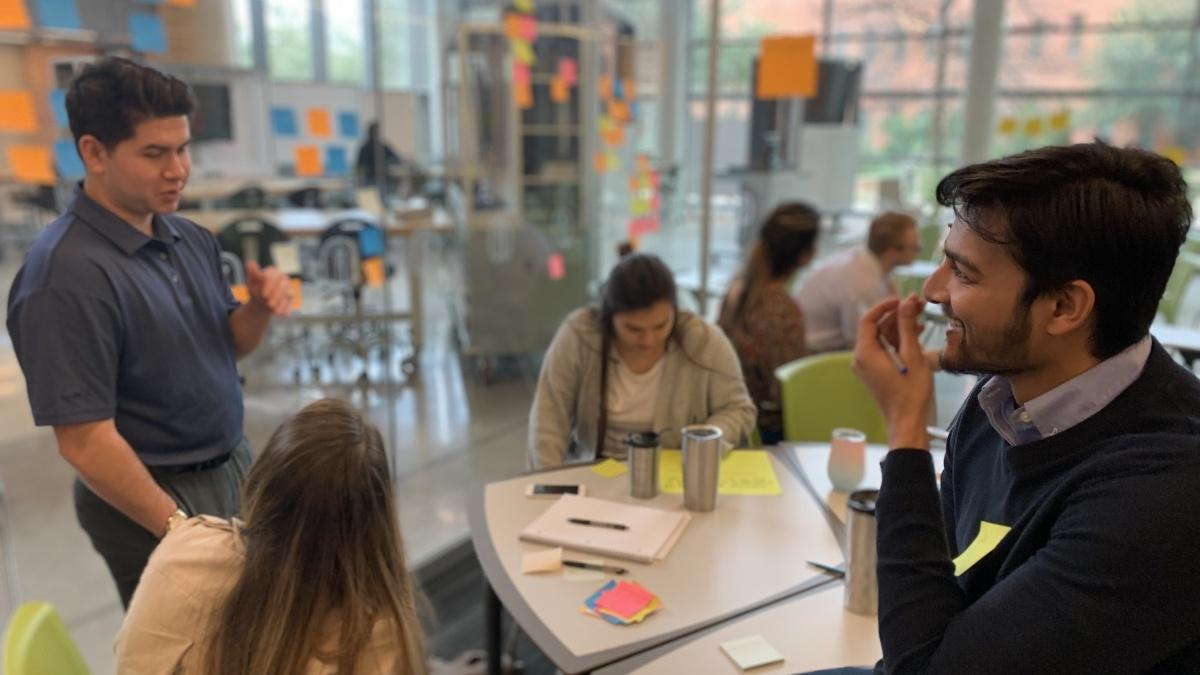 Students joyfully engage in a class excercise in the Trinity Innovation Room. 